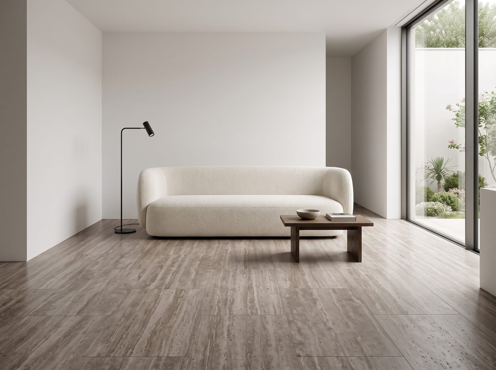 Calm lounge with a taupe vein-cut travertine floor, white bouclé sofa and black floor lamp
