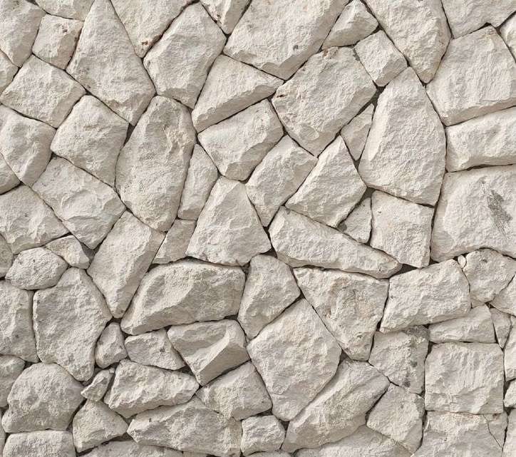Rockface limestone: polygonal light limestone pieces with cleft face