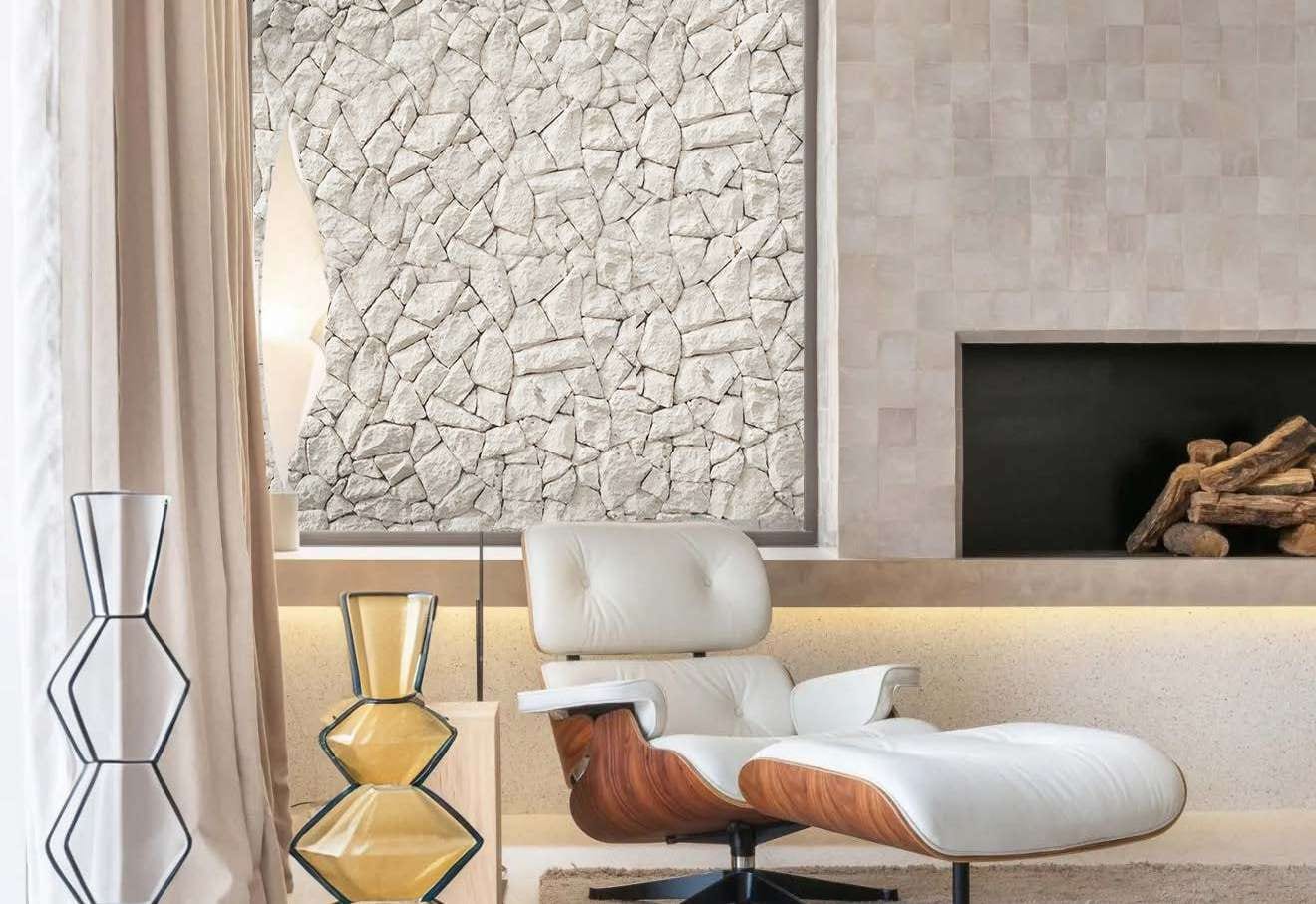 Living room with a wall of light polygonal limestone and a sea view