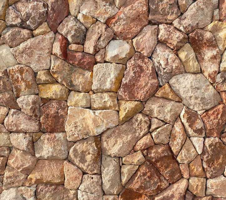 Rockface Scabos: polygonal travertine pieces in orange, red and gold