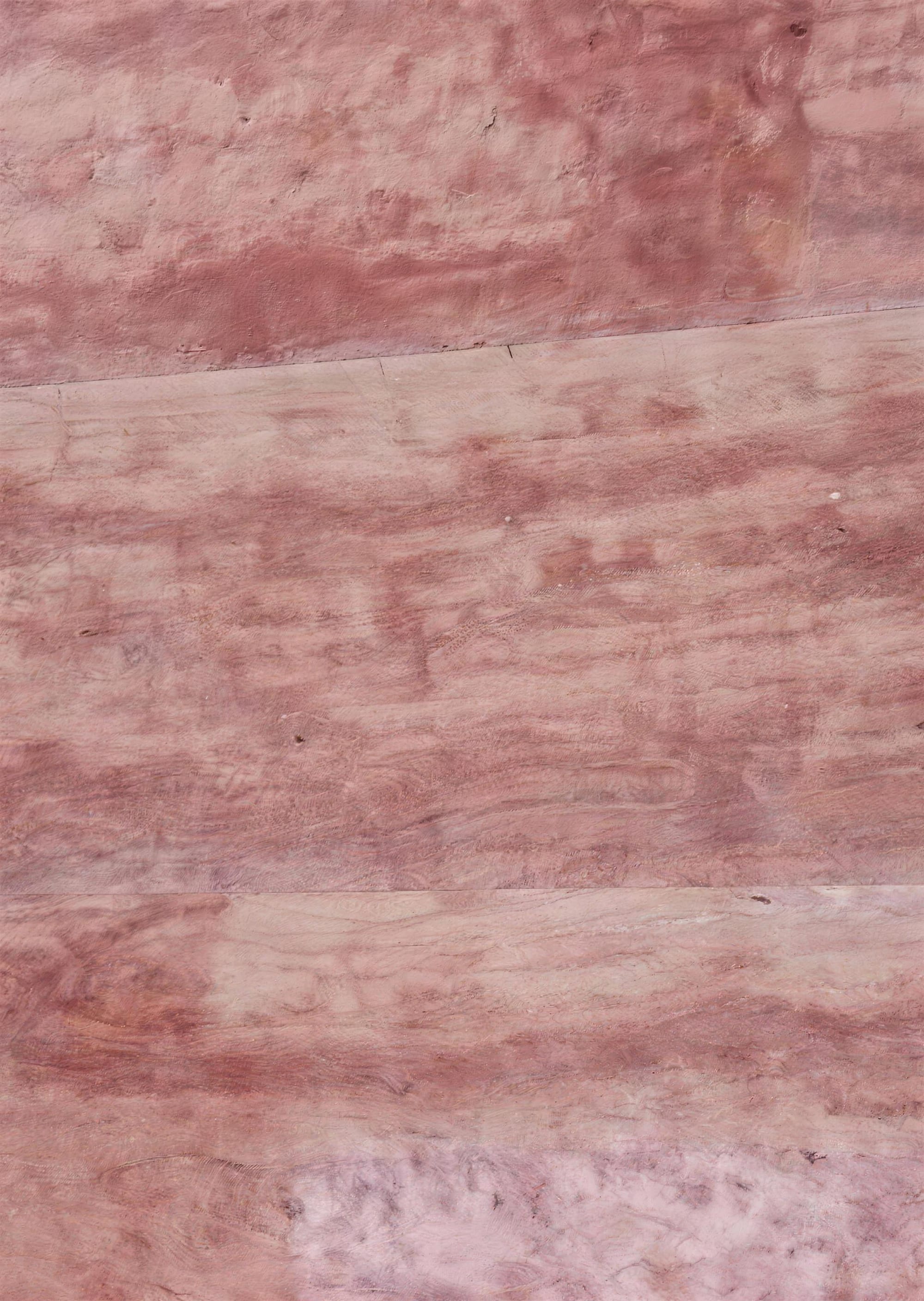 Rosso vein-cut: red-pink travertine with straight veins in burgundy and cream, polished, close-up