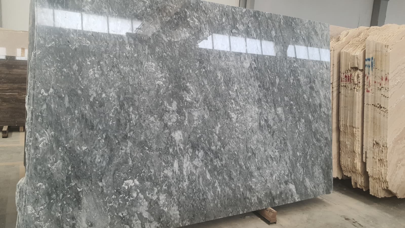 Slab Gris Nublado marble: Gris Nublado slab on an A-frame, close-up
