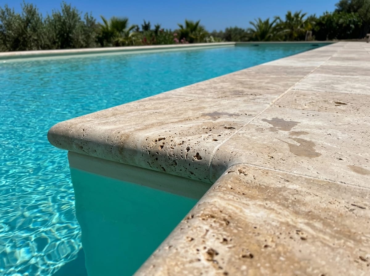 Pool with long Classic Mix travertine coping stones with rounded front edge